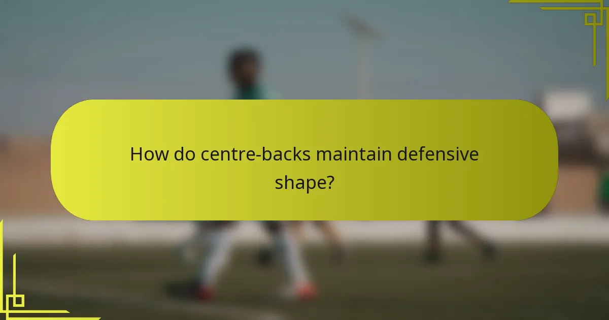 How do centre-backs maintain defensive shape?